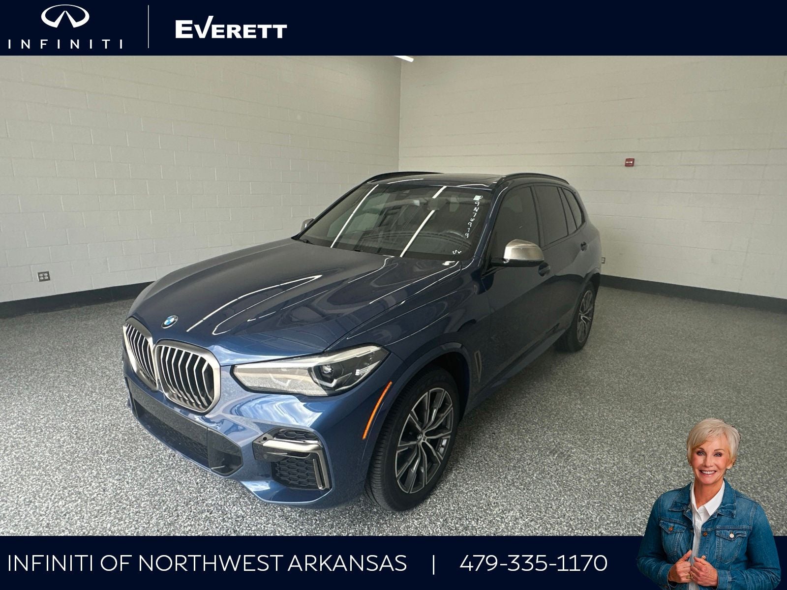 2023 BMW X5 M50i in Phytonic Blue Metallic — front three-quarter view